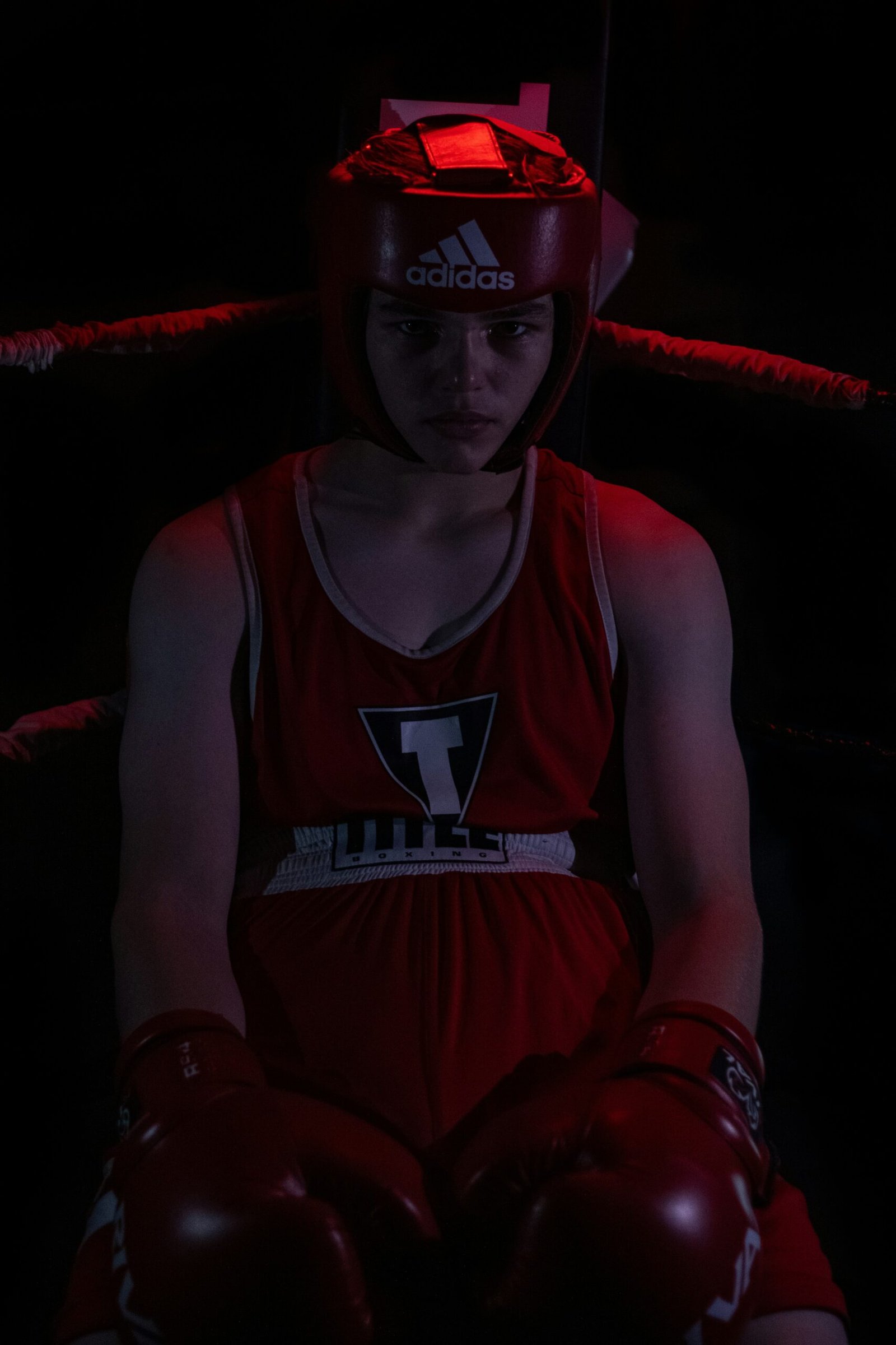 a young boy wearing boxing gloves and a red helmet